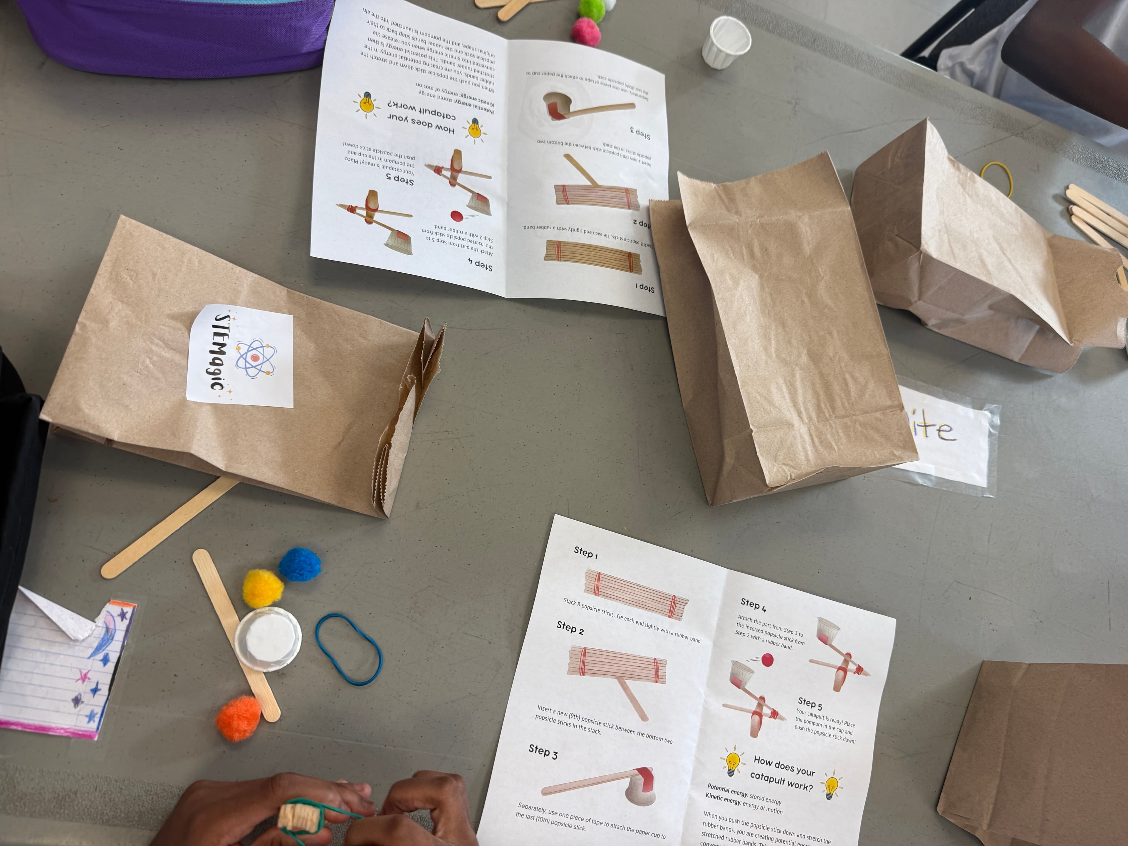 Catapult kits laid out with their hand-illustrated instruction booklets