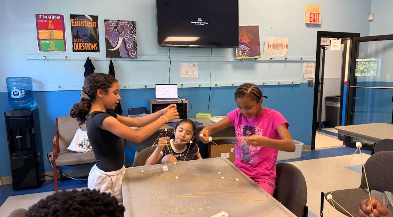 Students building a tower out of spaghetti and marshmallows